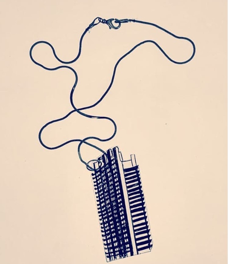 Sepia image of the Barbican themed pendant on a plain background.